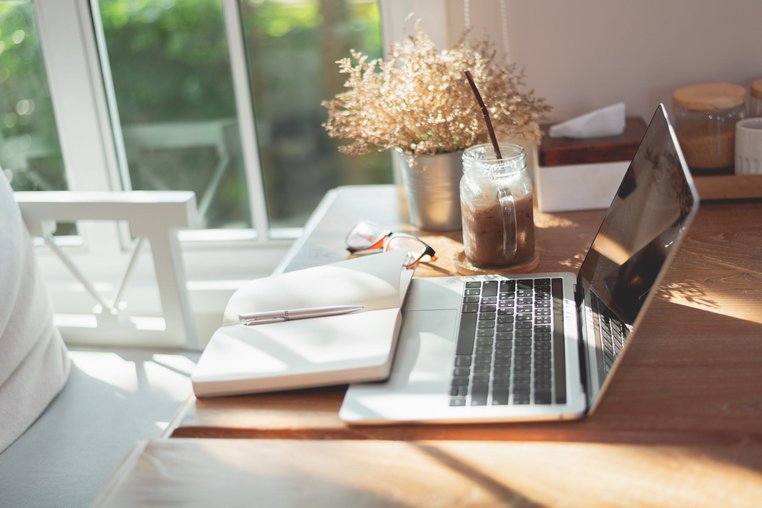 work space, laptop and note book on the table in the cafe, copy space business concept